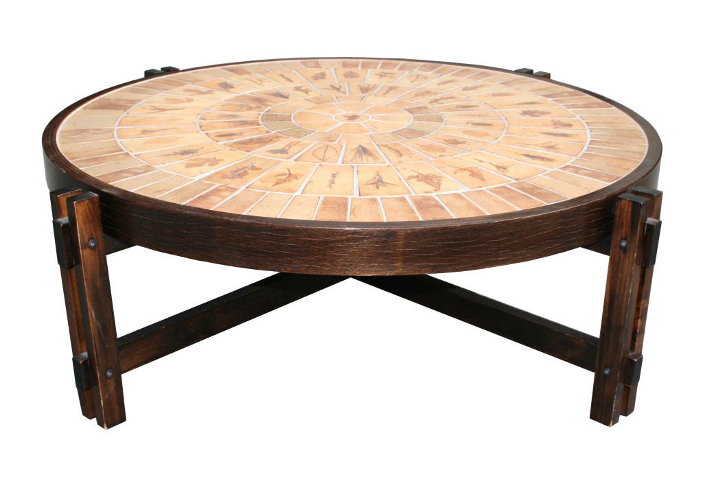 Two low tables by Capron Vallauris with mosaic tops comprised of stoneware tiles. Each tile impressed with a botanical design and has a warm hue. The centre tile on each table is circular and has a design of a maple or oak leaf. The tables are