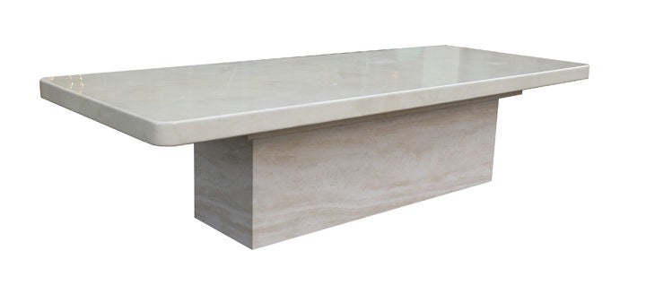 A 10ft. long lacquered goatskin and travertine dining table by Karl Springer. A gorgeous and oversized goatskin wrapped table top with a travertine base. The table top is solid with soft 3' radius rounded corners with a 3.5