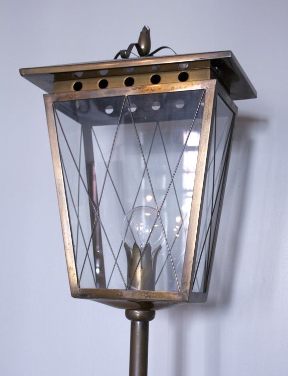A large standing lantern mounted on stand in bronze and glass by Pietro Chiesa for Fontana Arte, Italy, circa 1938. The lantern with removable top features a flaired case with bronze criss-cross diamond over glass. A similar lantern-form floor lamp