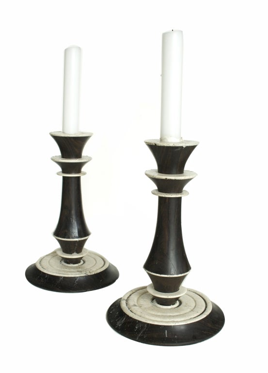 An elegant pair of candlesticks made of macassar and rosewood with limestone trim by Karl Springer.