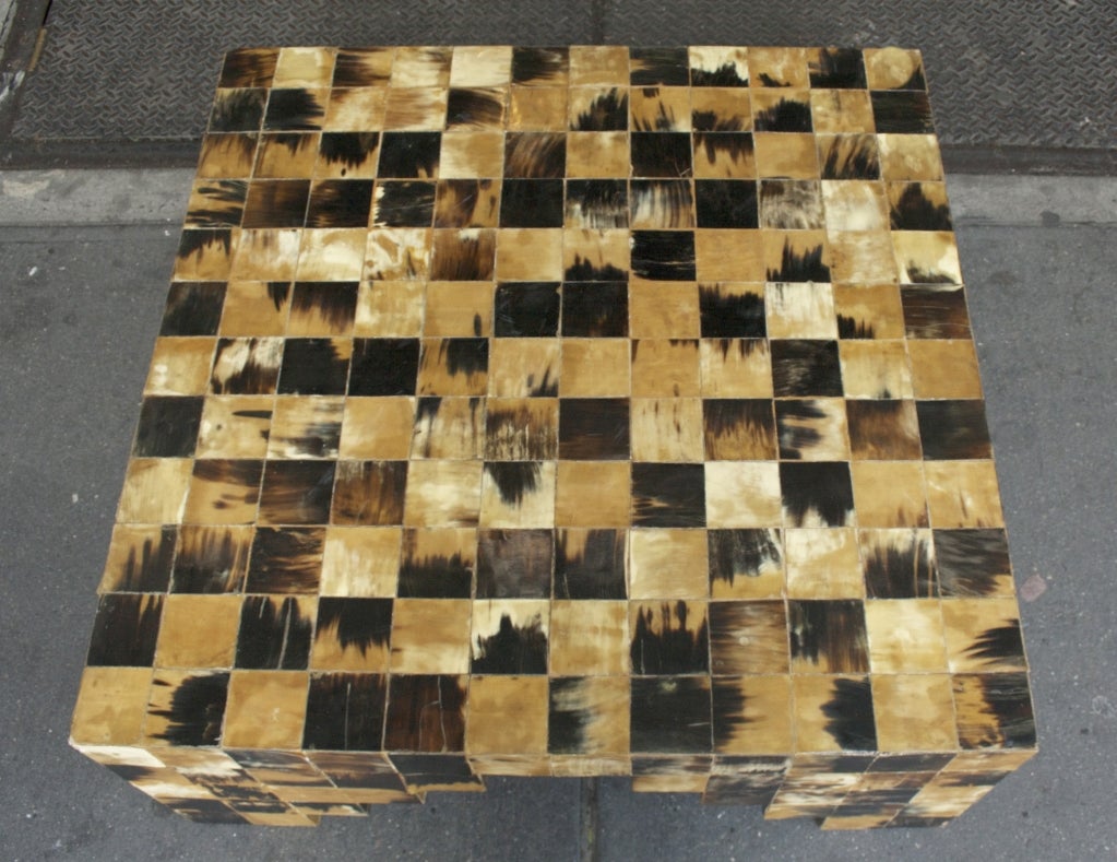A Rare Horn Cocktail Table by Karl Springer. USA, c.1975. A gorgeous and hard to find patchwork low table in cow horn. The delicate checkerboard of brown and tan horn adorn the top and sides of this beautiful table. The legs taper in a reverse