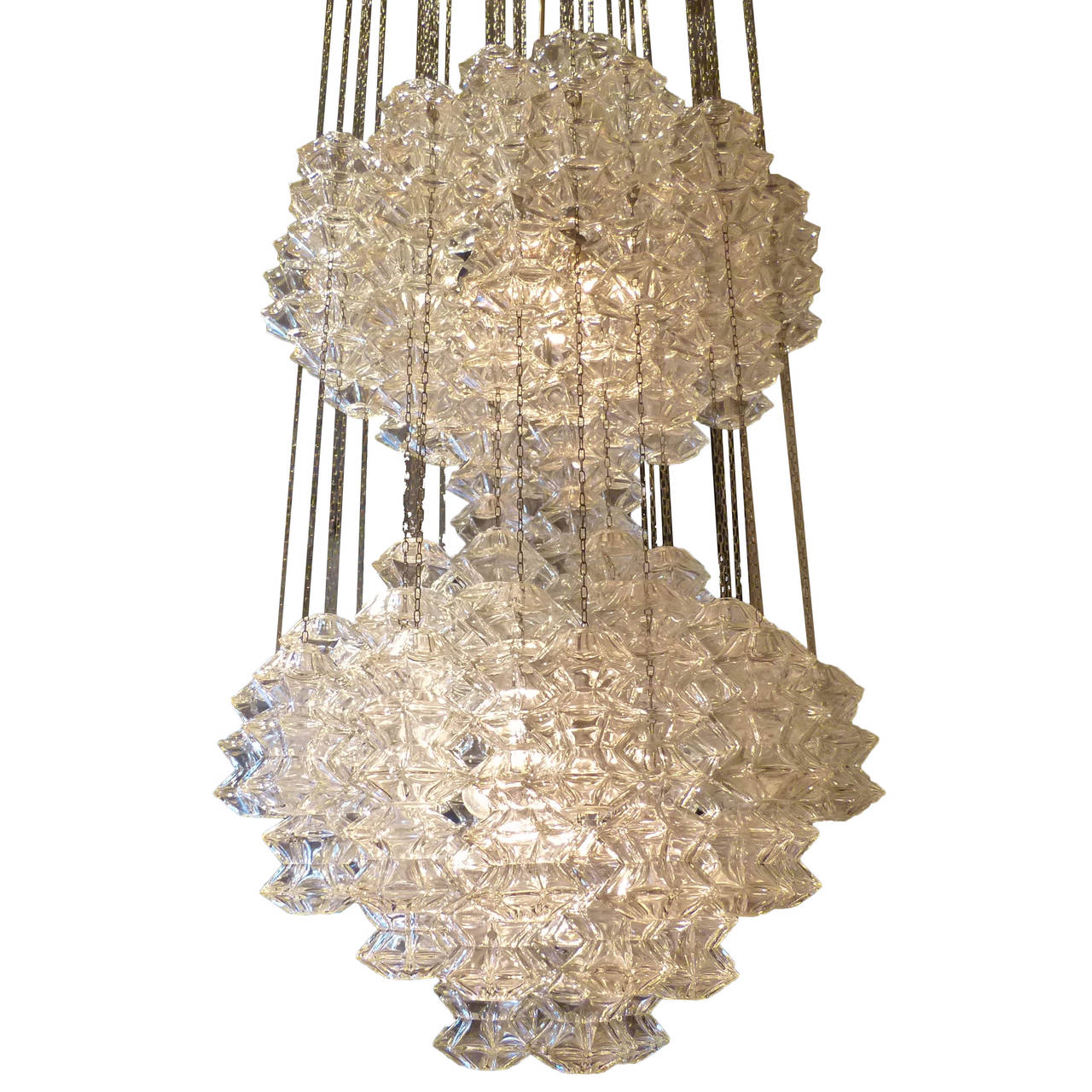 A large double “Pagode” crystal and chromed steel chandelier by Kalmar. The lamp features Kalmar’s unique crystal glass design hung in an elegant double tiered “Pagode” shape. The two large masses of crystal hang from thin metal chains off a chrome