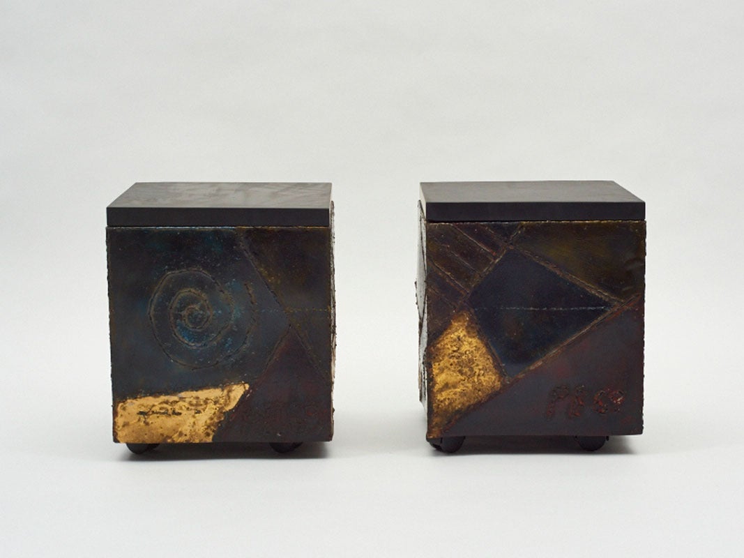 A unique pair of custom Paul Evans cubes on original, hidden casters from his series of welded steel works. Braised bronze details in the form of swirls, pinwheels and geometric planes divide each cube's surface, highlighting the rich autumnal color