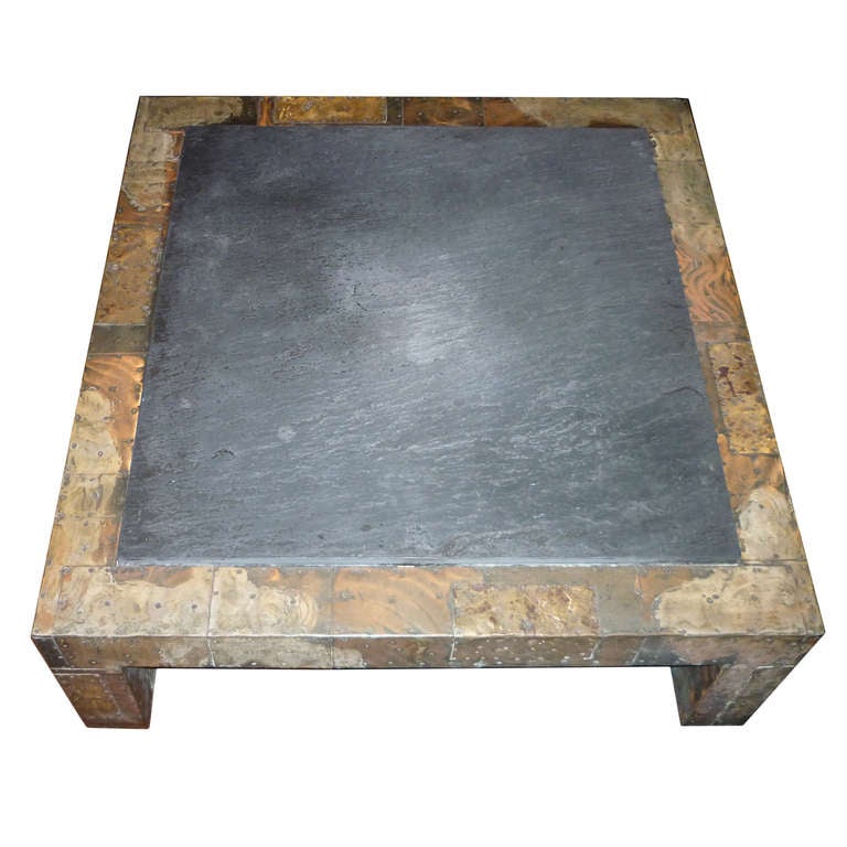 A Patchwork Coffee Table with Slate Top by Paul Evans, USA, c.1970s.

A cooper, bronze and pewter coffee- table by Paul Evans for Directional with slate top. Shingled copper is brazed with brass and pewter to create this series by Paul Evans.