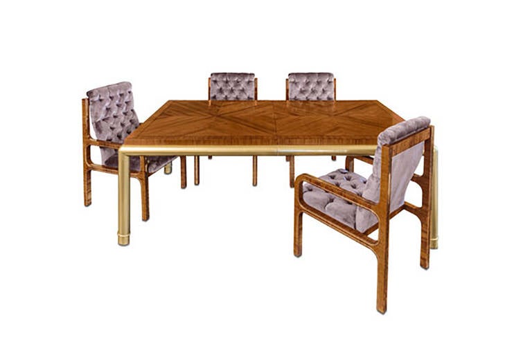 The table, in book-matched European walnut, features three leaves extending the table from 80 inches to 136 inches. The table top, in beautifully grained walnut, in a diamond pattern, is matched flawlessly and surrounded by tubular bronze with the