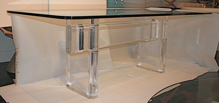 A massive lucite and glass dining table by Karl Springer signed Karl Springer, circa 1980s. Two massive 4