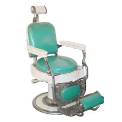 A Theo A. Koch Enamel and Chromed Cast Iron Barber Chair