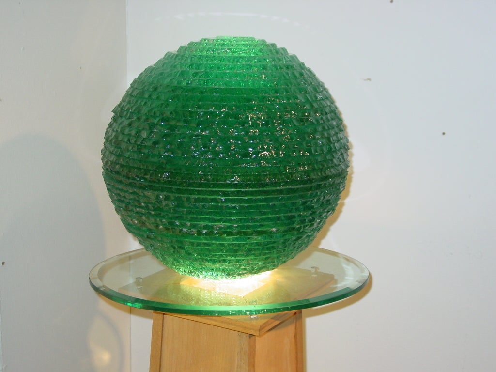 the chipped glass ball on a bevelled oval top on a tapering electrified plinth