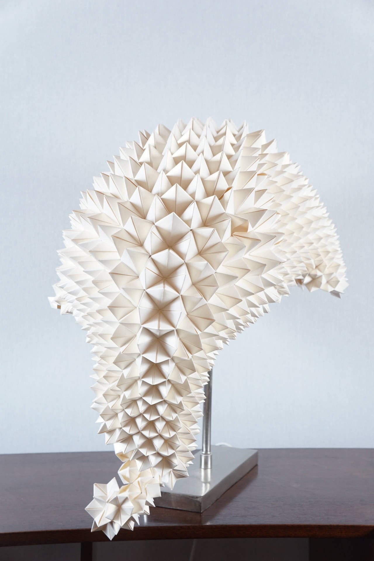 A Dragon's Tail Table Lamp designed by Luisa Robinson for Hive, constructed with folded paper.