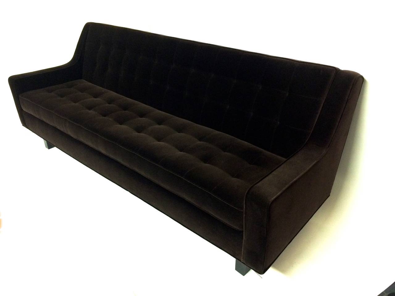 1950s Edward Wormley inspired sofa reupholstered; tufted in chocolate brown velvet.
Sits on four black, cubed wooden legs.