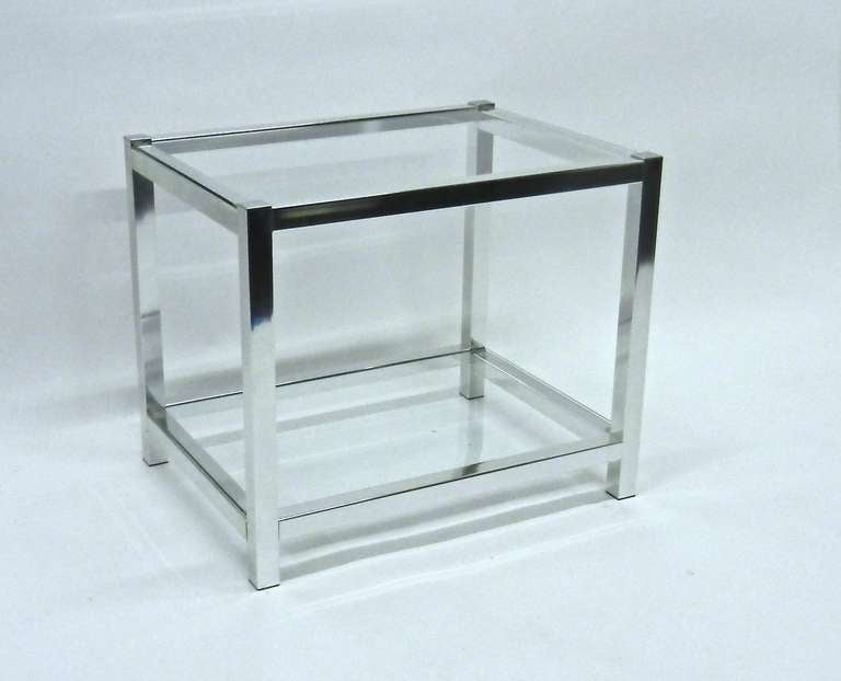 Cubic shaped chromed metal with glass insets on top and bottom end tables. Quarter inch glass.