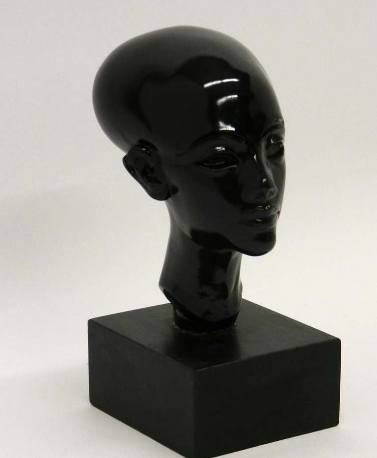 This hand-carved glazed plaster bust of Nefertiti sit on a wooden base.
Finished in high gloss black.