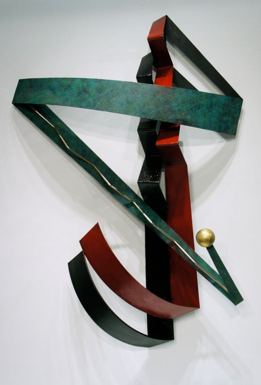 Zig-Zag composition by C. Jeré in steel with baked-on textured enamels of red, green and black, with patinated brass detailing. On the reverse side are several loops from which to hang this piece so that it may be positioned at various angles.