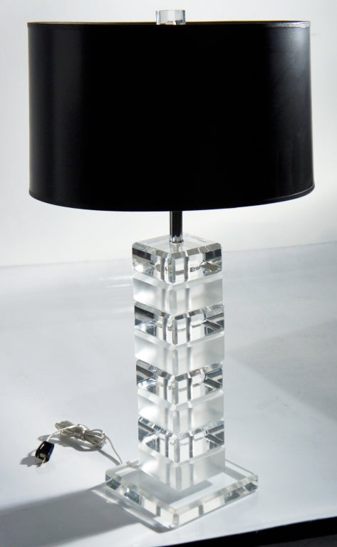 Modernist style combines with rich sensuousness in this subtly designed table lamp. A stack of eight solid Lucite blocks, each either frosted or crystal-clear, rests on a seven-inch square Lucite platform. All edges are beautifully chamfered, giving