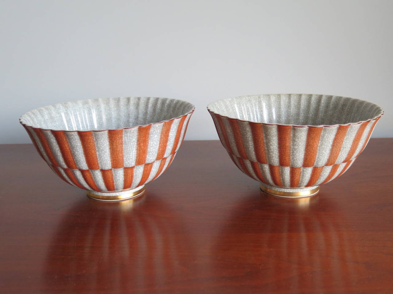 A pair of elegant, crackle glaze ceramic bowls by Royal Copenhagen, Denmark, circa 1940s. Coral and light gray deco pattern with gold details.