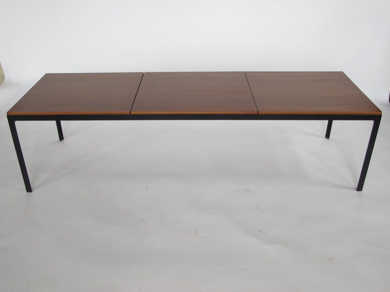A classic Florence Knoll angle iron coffee table with bookmatched walnut top.  Beautiful veneer, quality early Knoll production. Very practical and timeless, minimalist design.