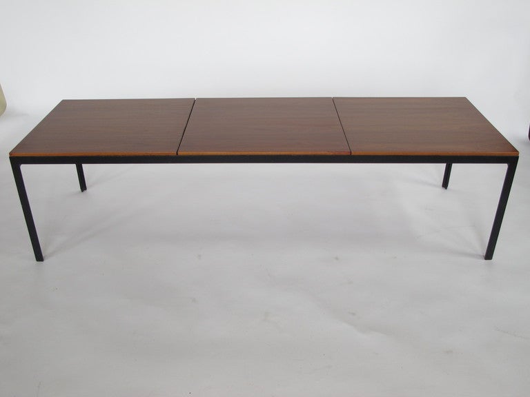 A classic Florence Knoll angle iron coffee table with bookmatched walnut top.  Beautiful veneer, quality early Knoll production. Very practical and timeless, minimalist design.