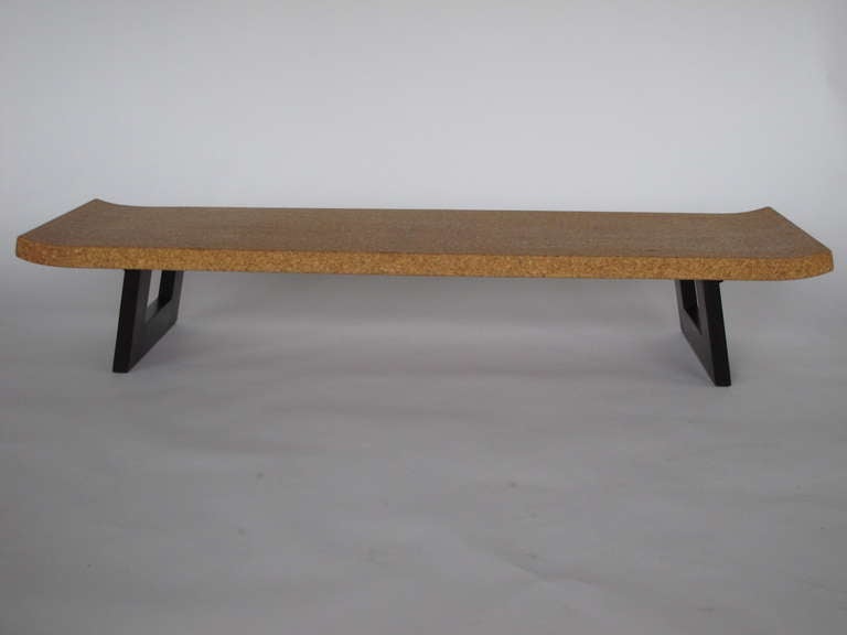 A classic Paul Frankl bench or low table for John Stuart. Mahogany construction with cork top and raised ends.
