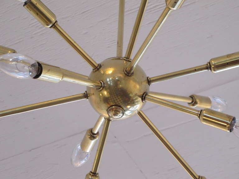 A polished brass Lightolier chandelier with 12 arms.