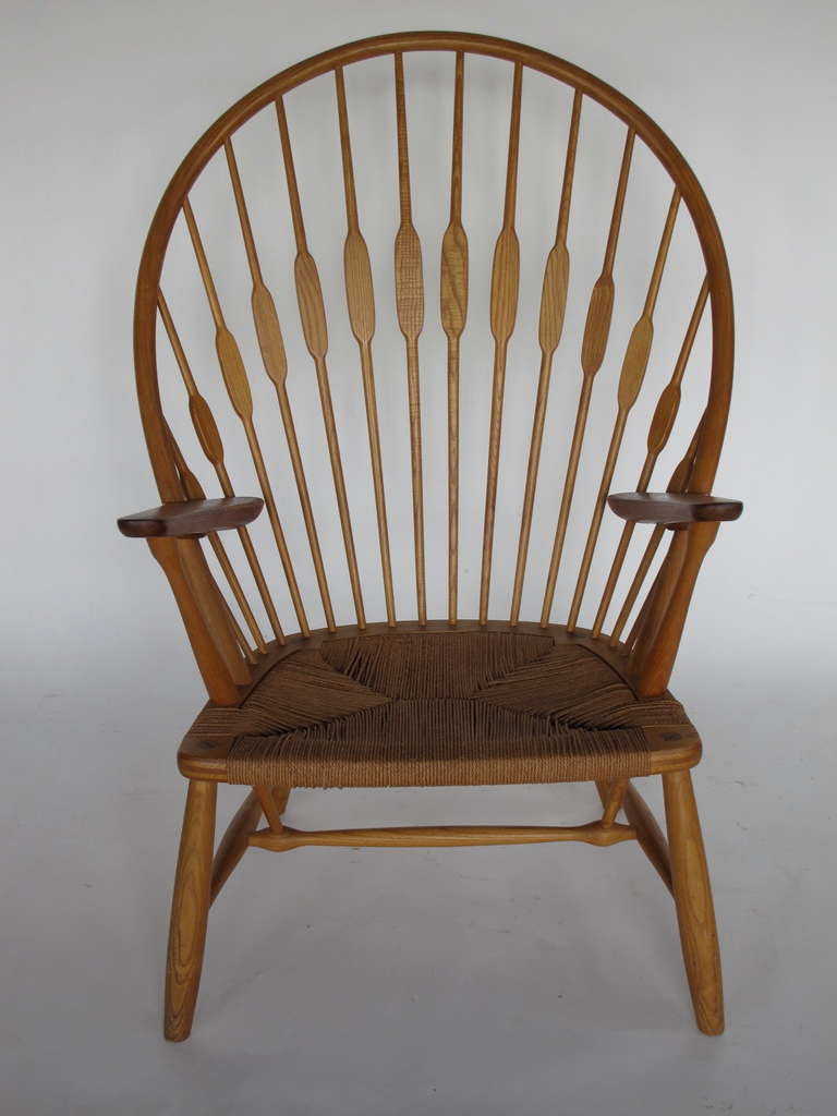 A classic Hans Wegner for Johannes Hansen Peacock chair. Ash, teak, cord seat.