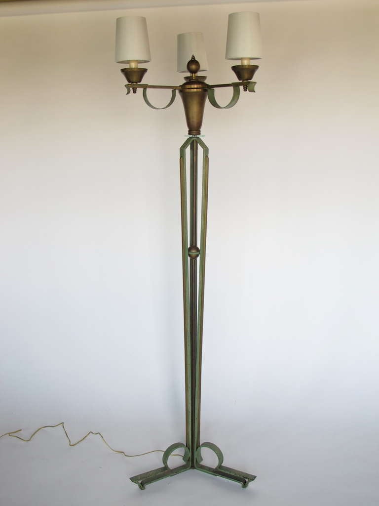 An elegant and impressive floor lamp by Arlus, in patinated wrought iron, brass, glass. This lamp is heavy and has great presence.