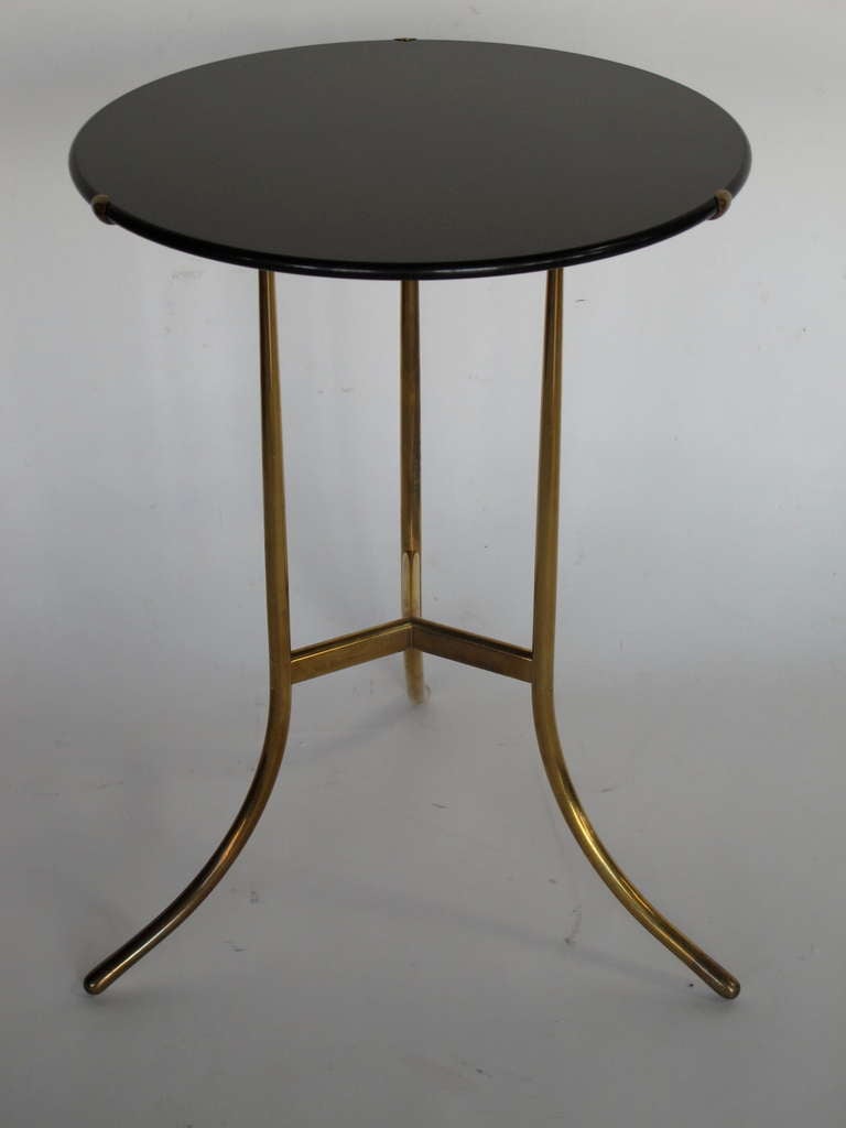 A classic Cedric Hartman table. Polished brass base with honed black granite top. Signed and numbered.