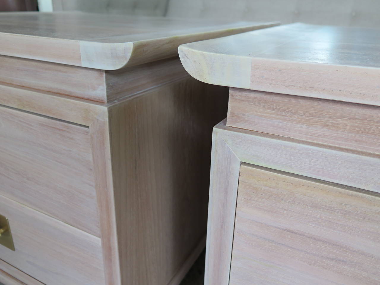 A great pair of Chinese style nightstands. Elegant raised edges, heavy, solid brass newly polished hardware (brushed satin lacquered finish). The cabinet backs are finished. New white wash/pickled finish.