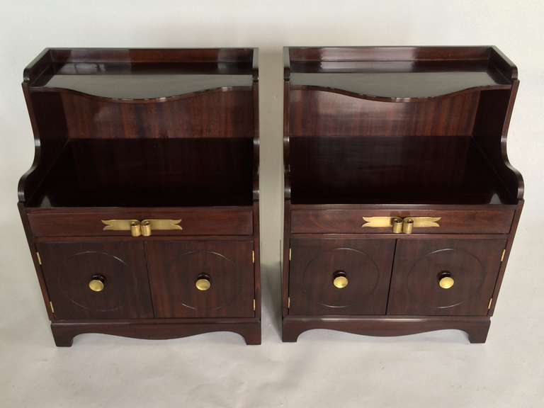 A pair of elegant nightstands by Grosfeld House, circa 1940s. Polished brass hardware, mahogany.