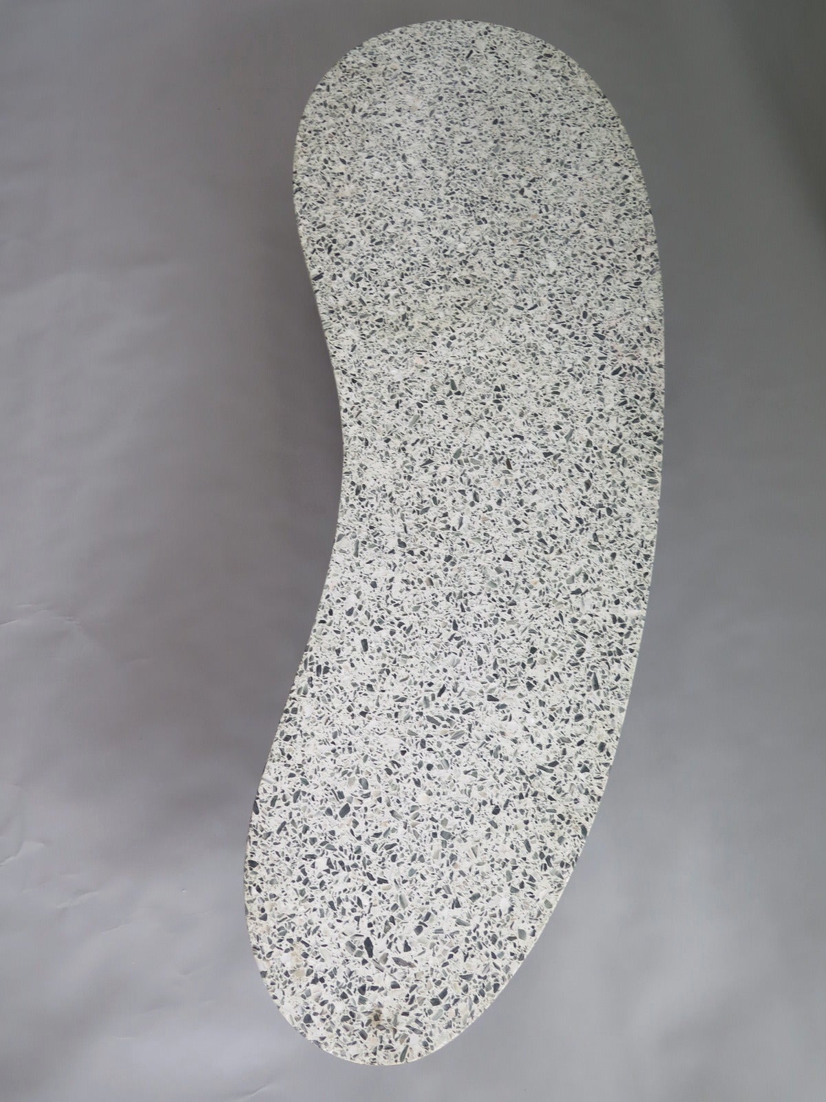 An interersting, low terrazzo coffee table. Brass legs, curvy biomorphic shape.
