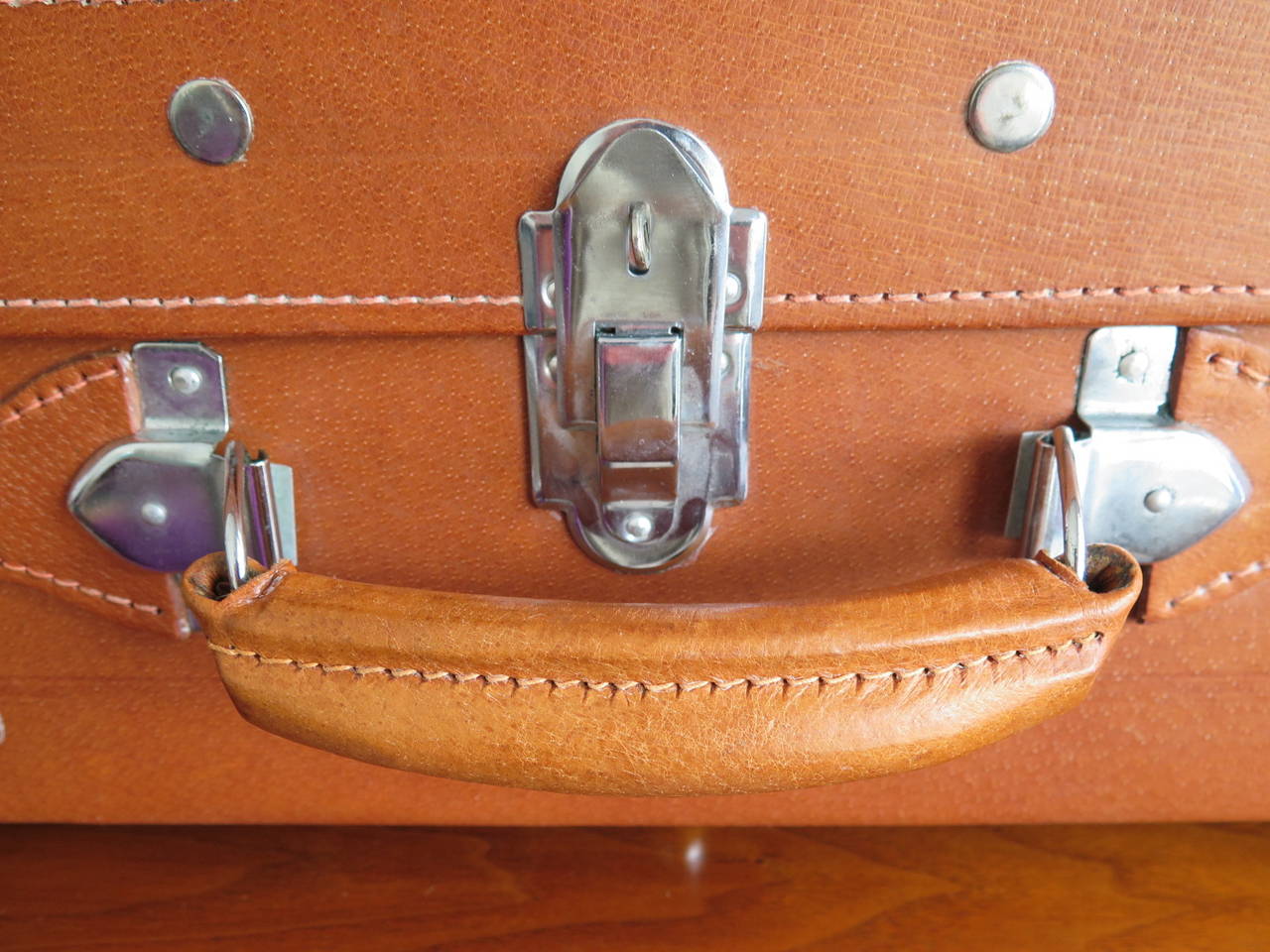 An interesting set of four heavy leather suitcases. Vintage 1960s in unused, excellent, near mint condition with keys. Largest measures 18
