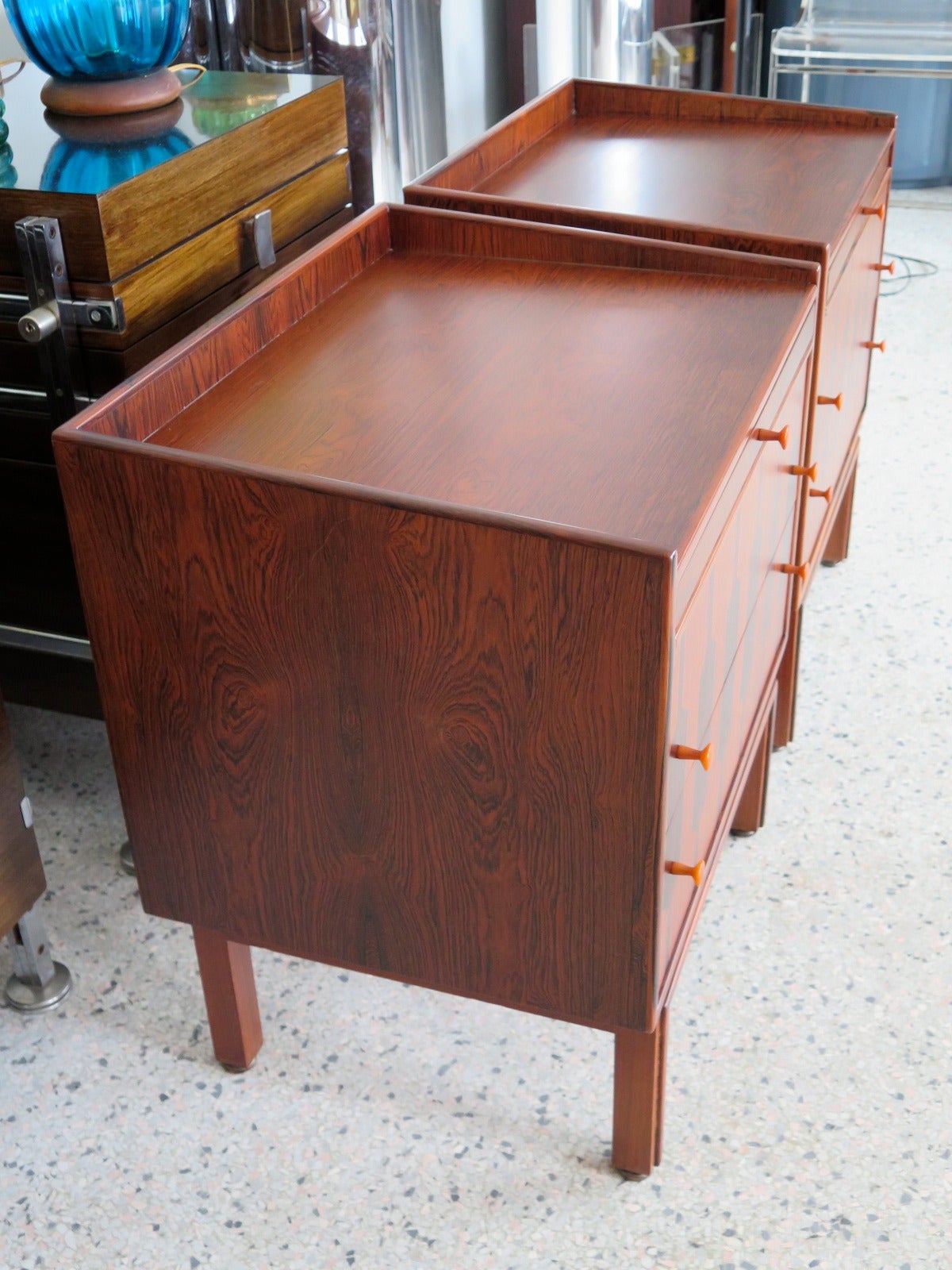 A pair of unusual nightstands in rosewood by Rom Weber. Bakelite handles, pull-out top tray, decorative pattern front.