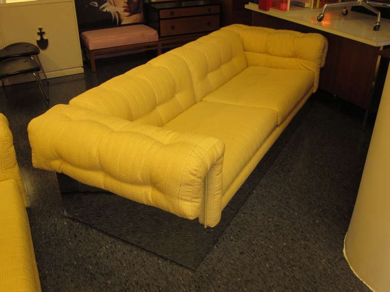 A great pair of 1970's Milo Baughman sofas, in original pale yellow upholstery. Chromed/mirror polished bases.