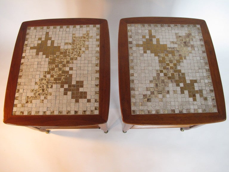 An interesting pair of nightstands in sap walnut, brass sabots, tiled tops. Classic mid century look-quality construction.