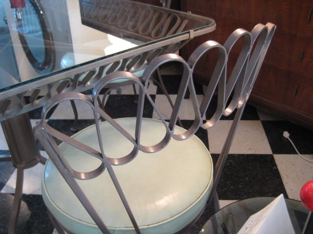 A Wrought Iron Outdoor Dining Set by Salterini with Bar Stools