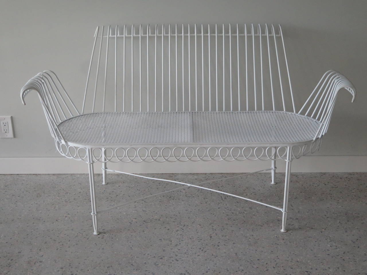 An elegant wrought iron settee by Mathieu Mategot.