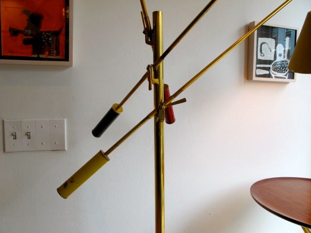 A signed, Arredoluce three arm floor lamp known as triennale. Overall good vintage condition-a rare find. Classic colors-yellow, red and dark blue.