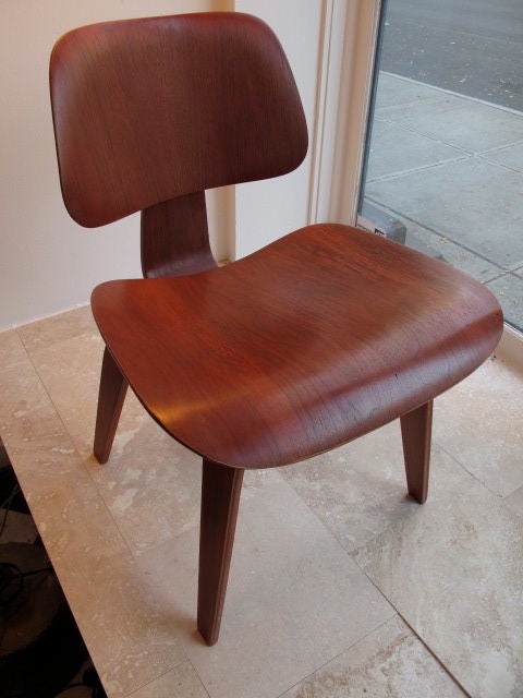 Un classique, original, de la première production de Charles Eames Evans Products, DCW (dining chair wood) en teinture analine rouge.