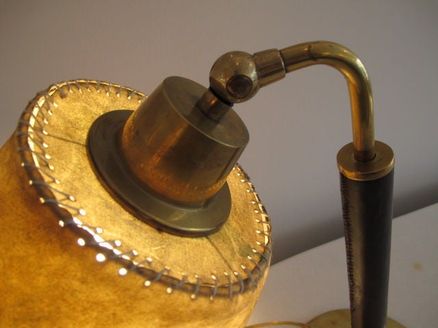 A modernist table lamp, leather by Hermes (signed). Original parchmnet shade, polished brass base.