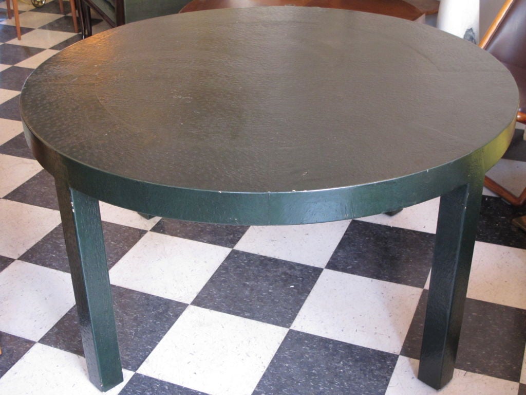 A stylish game table covered in dark green leather.