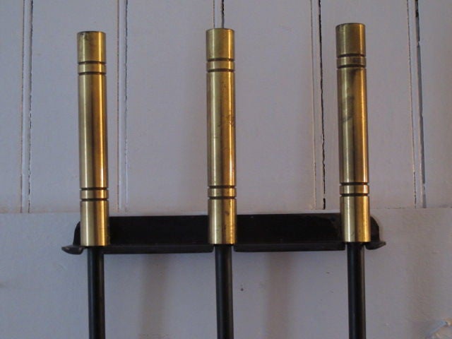 A great 1950's modernist set of firetools, brass handles, original mounting bracket.