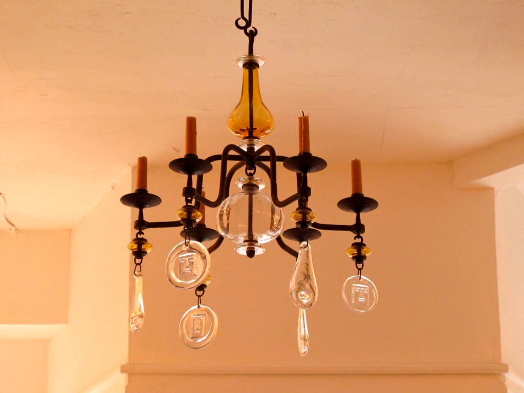 A whimsical six arm candelabra by Eric Hoglund for Boda in yellow and clear decorated glass. Note the extra long wrought iron chain.