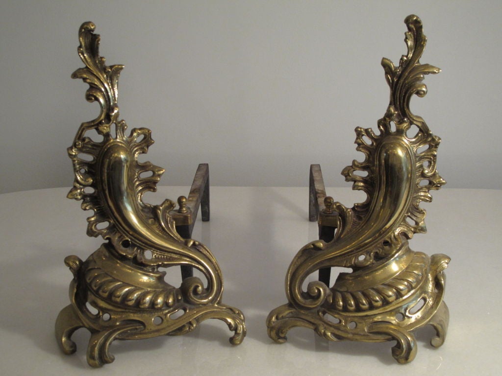 A pair of elegant Baroque style andirons in brass.