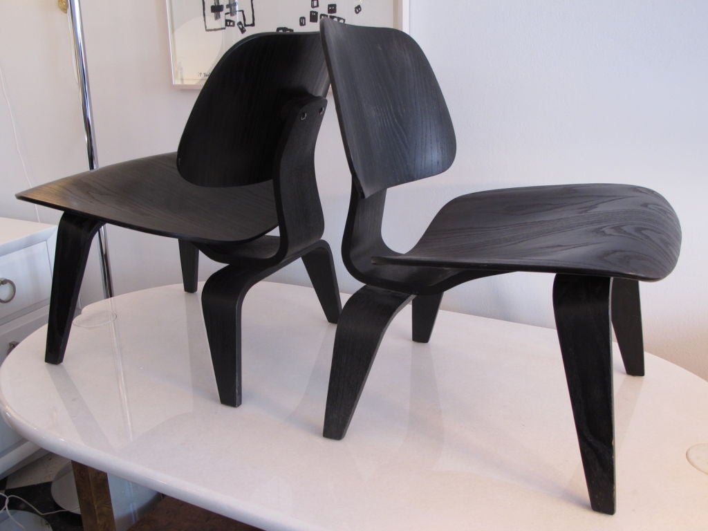 Ein seltenes Paar der frühen Produktion (5x2x5 Schraubbefestigungen) Charles Eames LCW (Lounge Chair Holz). Originale schwarze Analine-Lackierung in sehr gutem Zustand. Hintere Stoßdämpfer ersetzt. Preislich als Paar zu verkaufen.