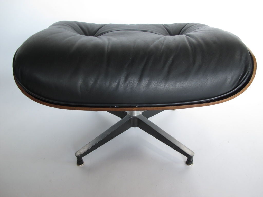 A classic Charles Eames for Herman Miller ottoman (671). Black leather and rosewood shell.