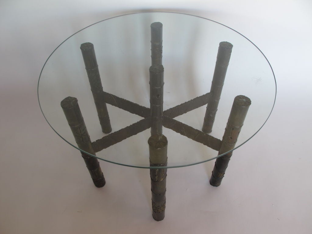 A Paul Evans coffee table, welded and patinated steel, with glass top.