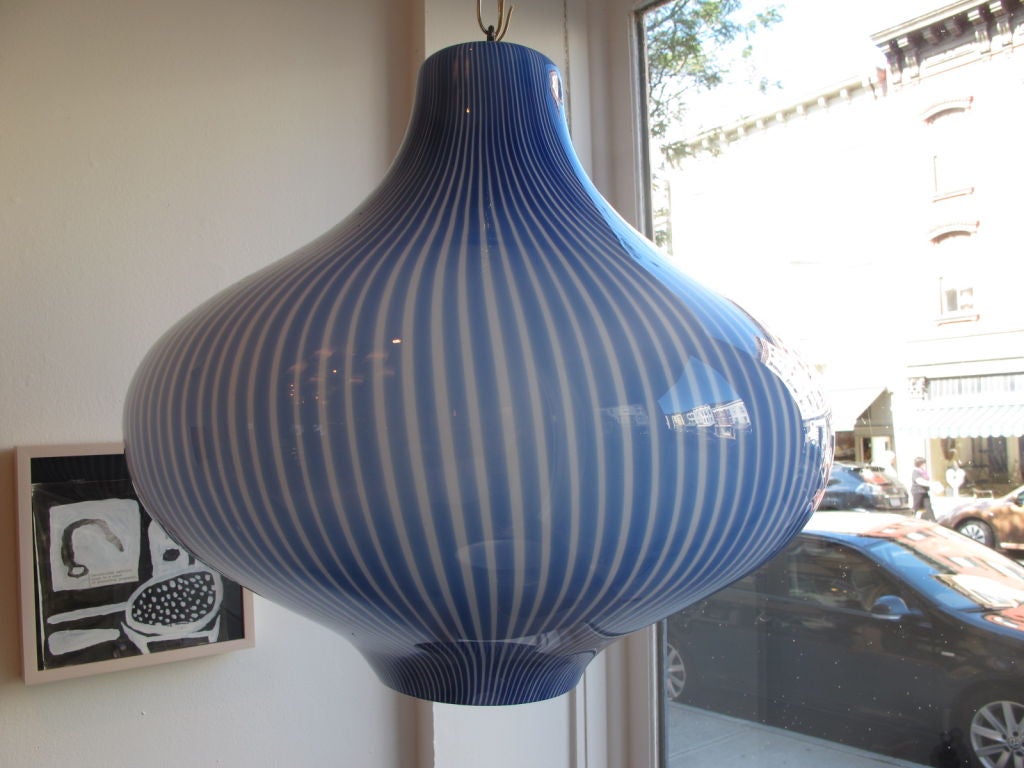 A fantastic onion shaped hanging lamp by Venini. Cased glass with blue and white stripes.