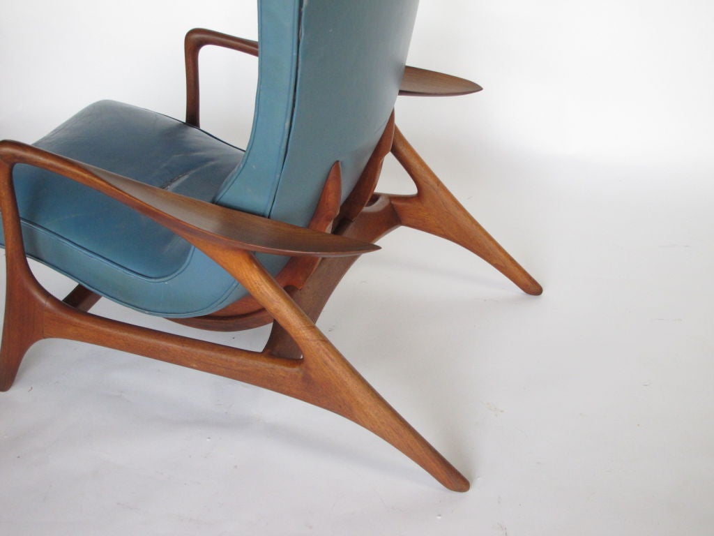 A rare Vladimir Kagan (signed Kagan Dreyfuss) multi-position reclining chair with extendable footrest. Trademark Kagan sculptural form with paddle-fin arms. Solid walnut frame, original blue leather upholstery.