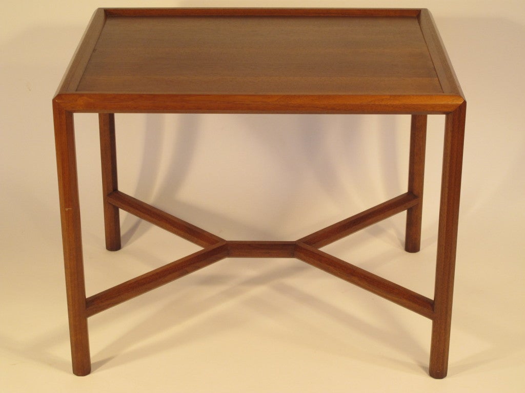 A classic occasional table by Edward Wormley for Dunbar. Sap walnut top, faceted legs.