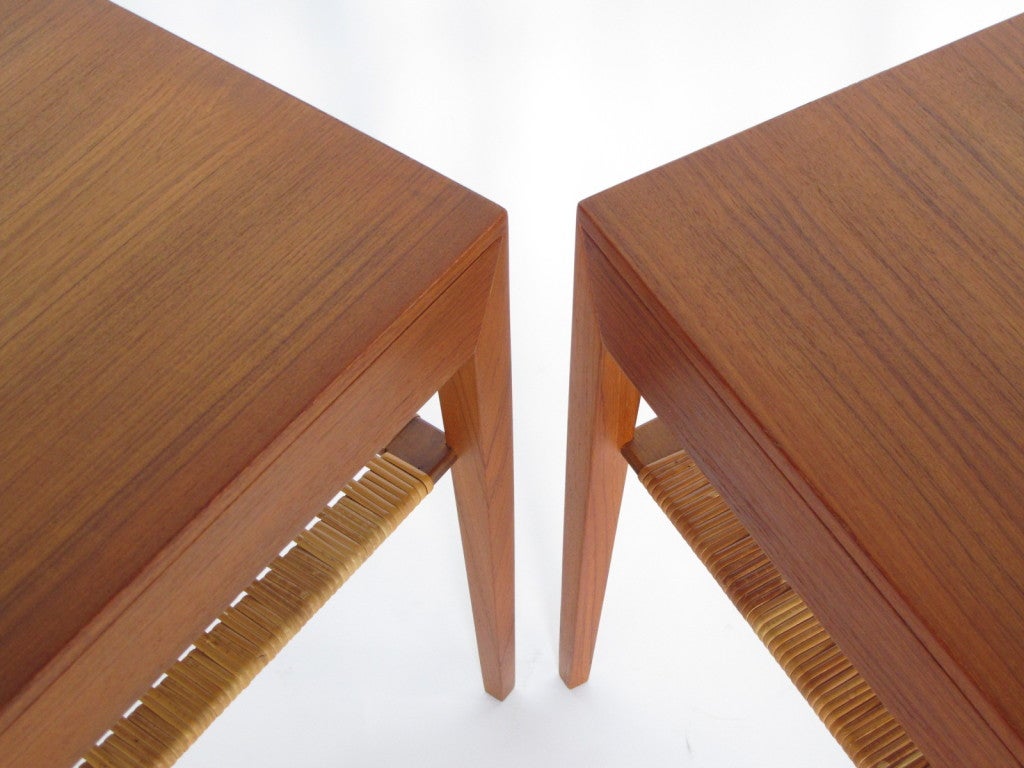 A pair of Danish minimalist nightstands by Severin Hansen for Haslev. Single drawer with caned lower shelf.  Elegant tapering legs.