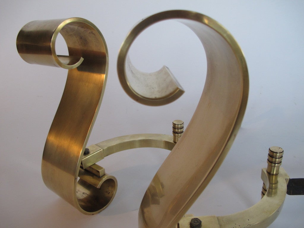 A pair of hand polished, decorative brass, scroll andirons. Heavy and very well made, thick gage.